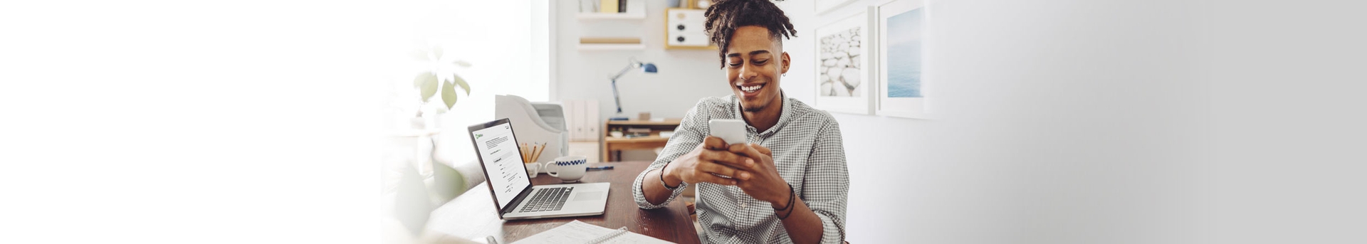 A man opening a checking account on his laptop.