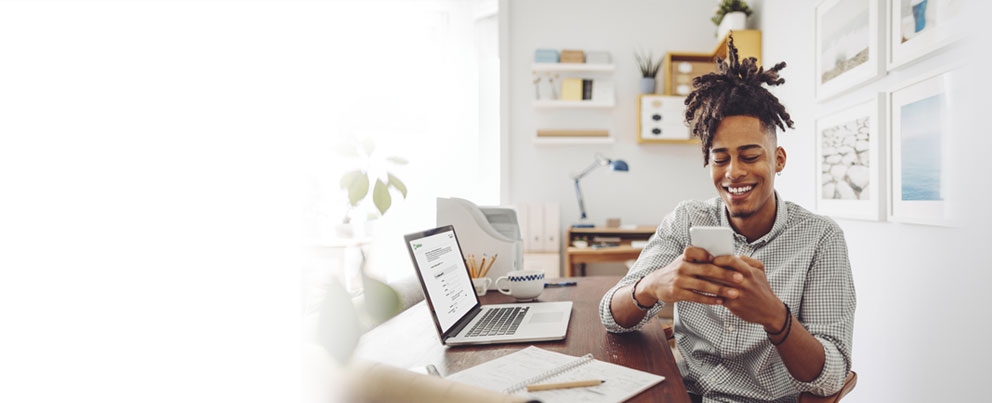 A man opening a checking account on his laptop.