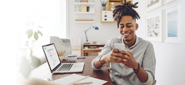 A man opening a checking account on his laptop.