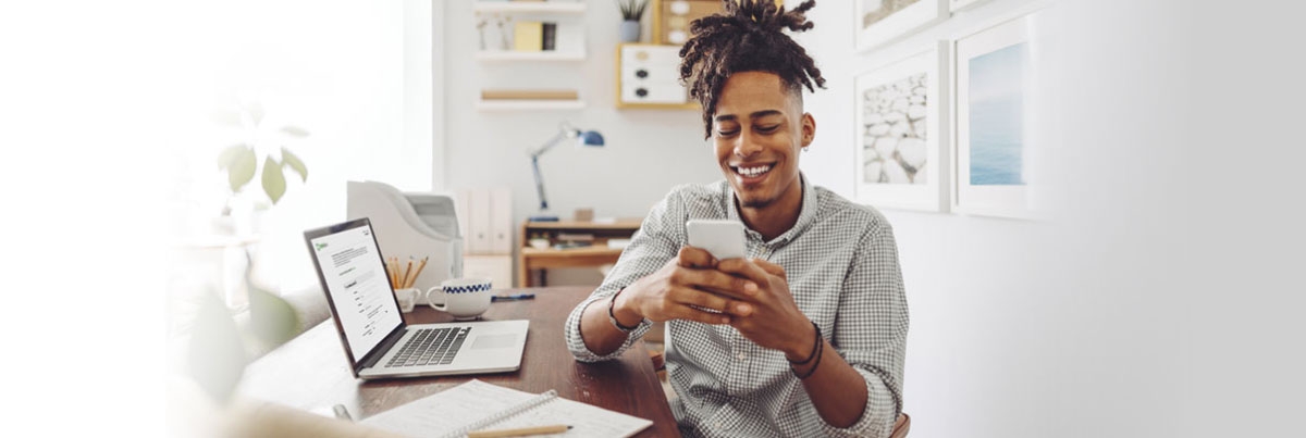 A man opening a checking account on his laptop.