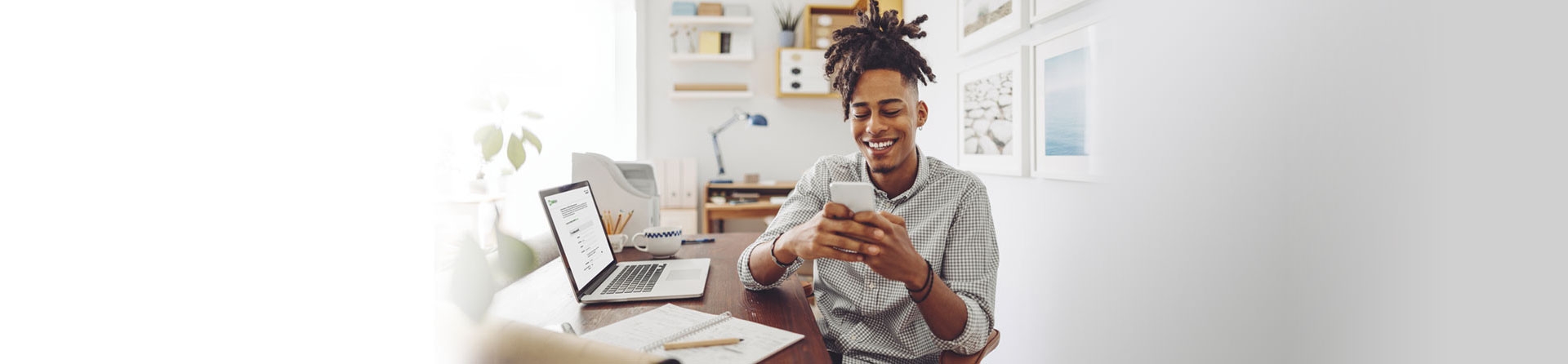 A man opening a checking account on his laptop.